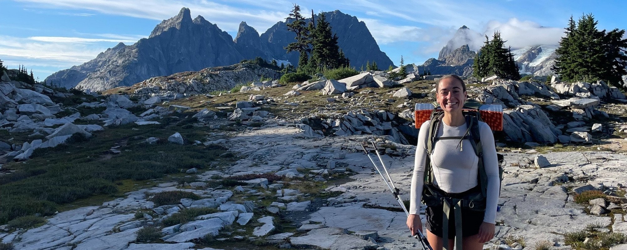 Brooke takes a break from hiking and poses in front of a mountain peak somewhere in the Pacific Northwest.